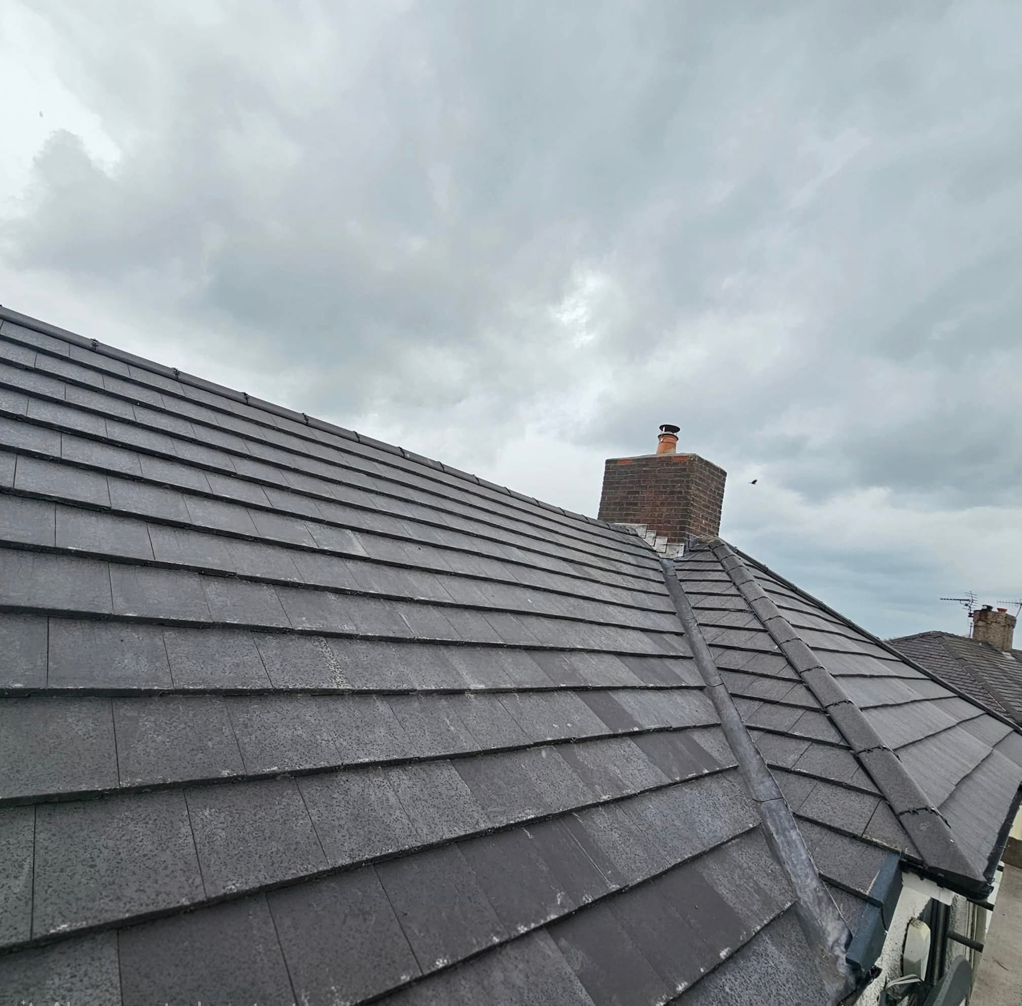 Clay roof tiles against a clear blue sky